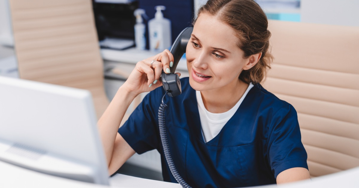 receptionist at a doctor's office answering the phone